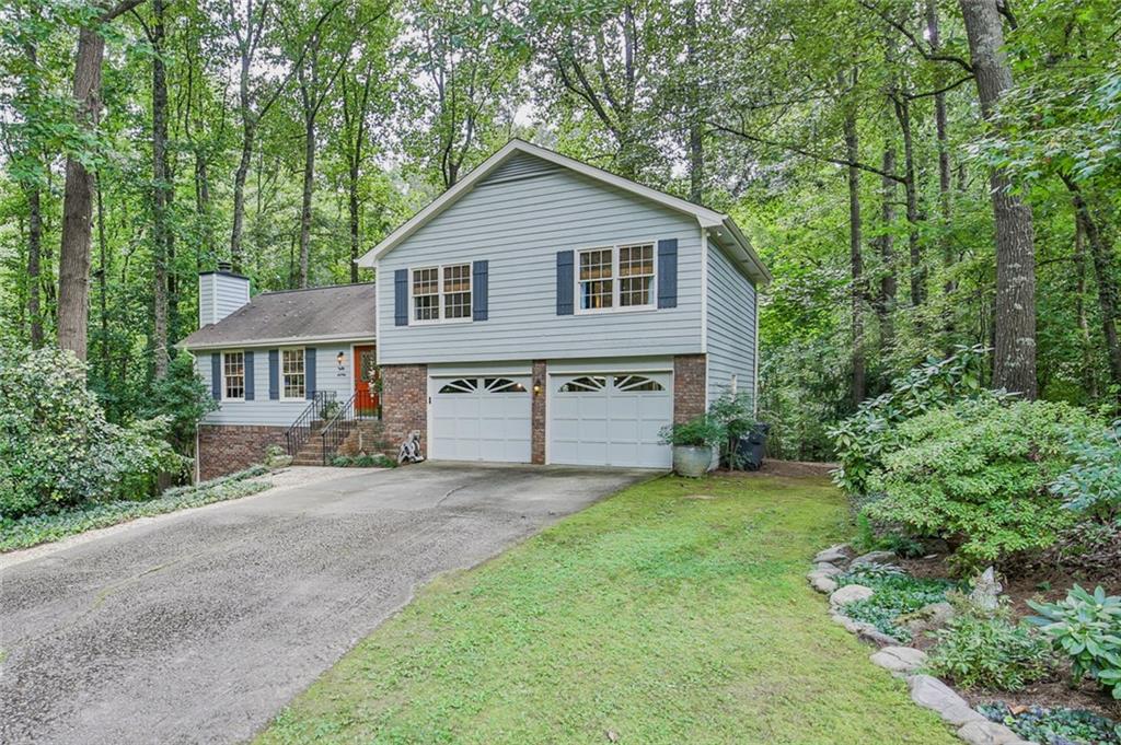5142 Suwanee Dam Road Suwanee, GA 30024 - Photo 1 of 1 a front view of a house with a garden and yard