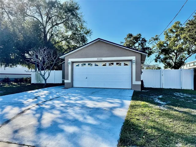 a view of a house with a yard and garage