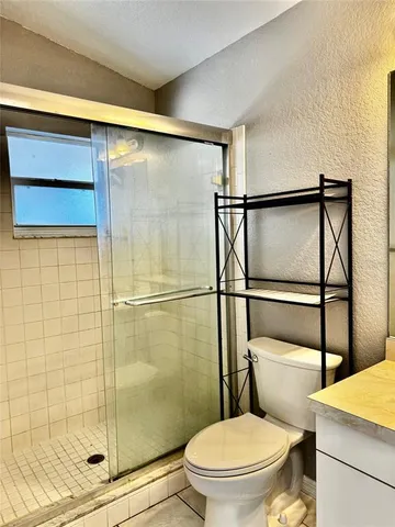 a bathroom with a toilet and a shower