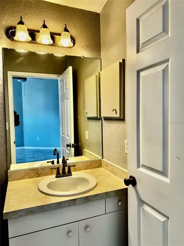 a bathroom with a sink and a mirror