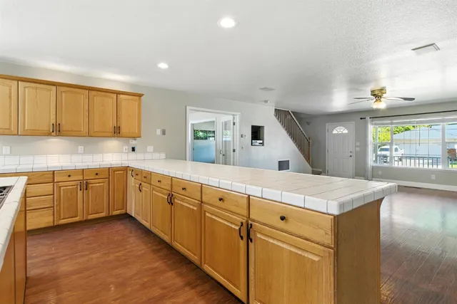 a kitchen with counter top oven sink and cabinets