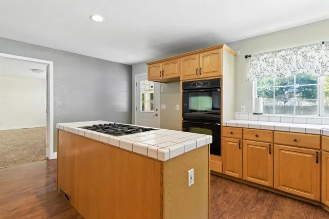 a kitchen that has a sink and a stove in it