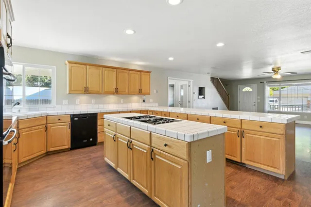 a kitchen with a stove top oven sink and cabinets