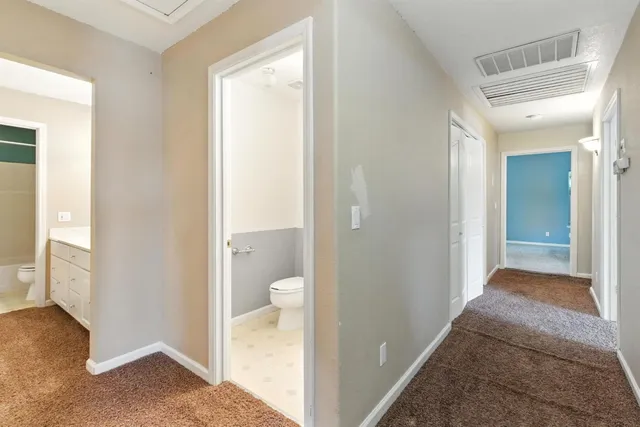 a view of a bathroom from a hallway