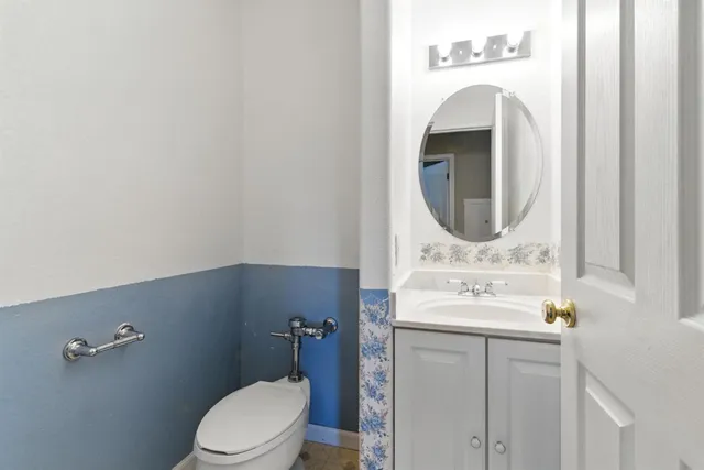 a bathroom with a sink mirror and toilet
