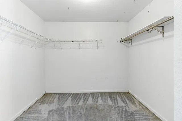 a spacious bathroom with a granite countertop sink a mirror and a shower