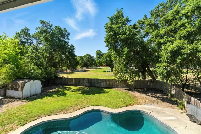 a view of a house with backyard and porch