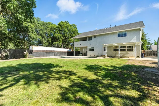 a swimming pool with outdoor seating and yard