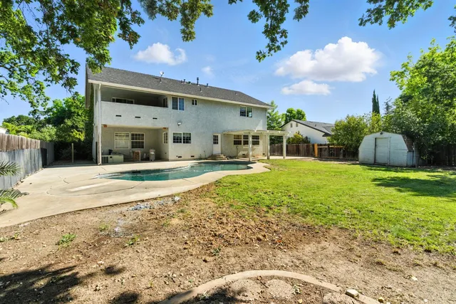 a view of a swimming pool with an outdoor space and seating area