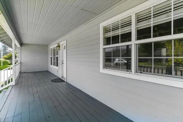 a view of front door with wooden floor and a stairs