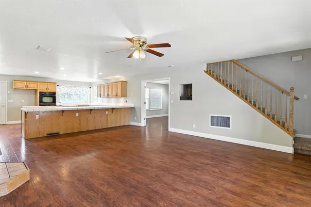 a view of a kitchen with furniture and wooden floor