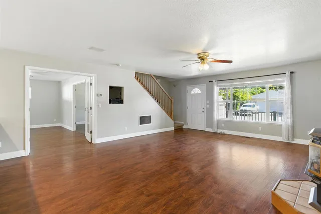 wooden floor in an empty room with a window