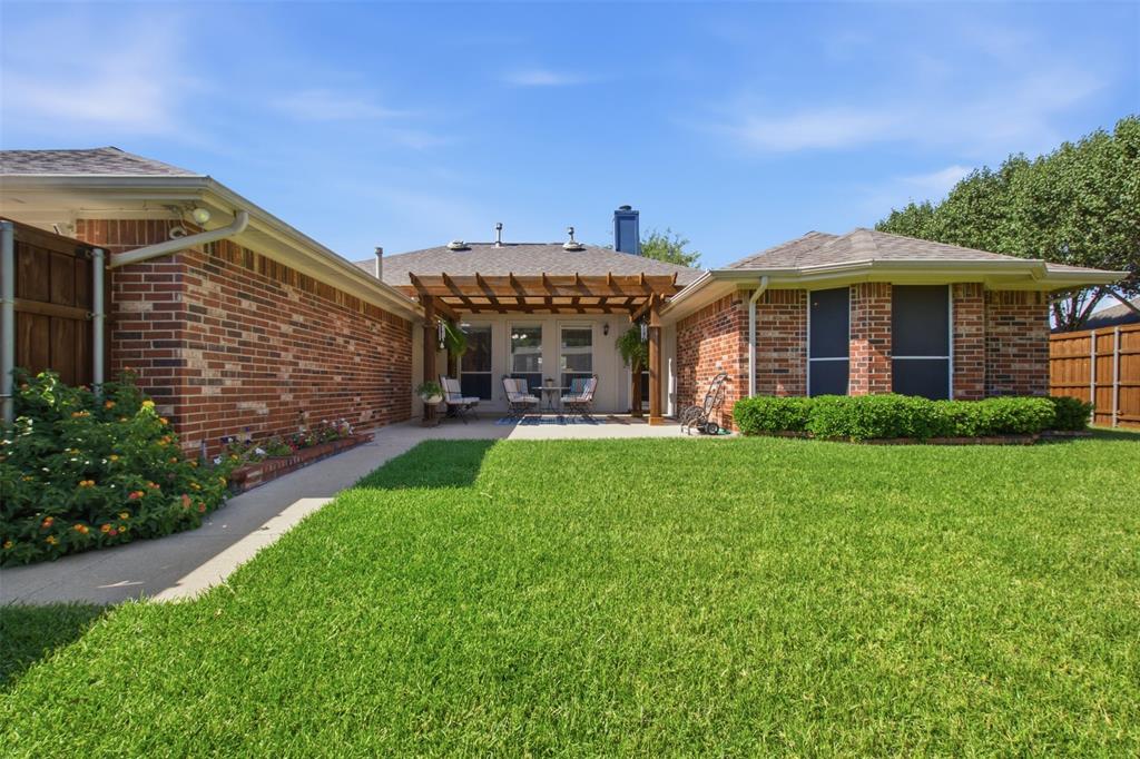 4218 Glistening Spring Rowlett, TX 75088 - Photo 35 of 39 Manicured lawn with brick exterior, covered patio, and perimeter fencing