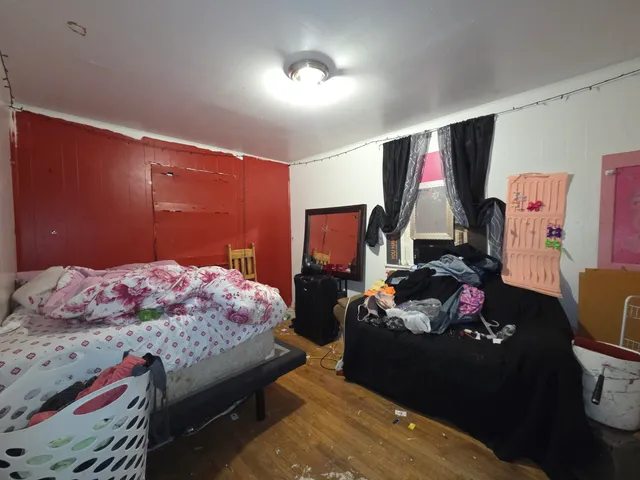 a bedroom with bed and a window