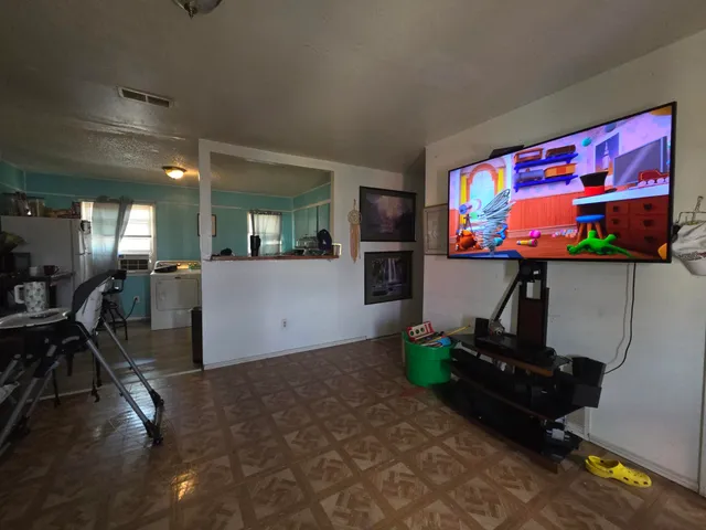 a room with furniture and flat screen tv