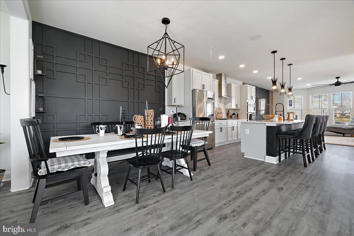 21 Greensborough Road Reisterstown, MD 21136 - Photo 15 of 54 a dining room with furniture a chandelier and wooden floor
