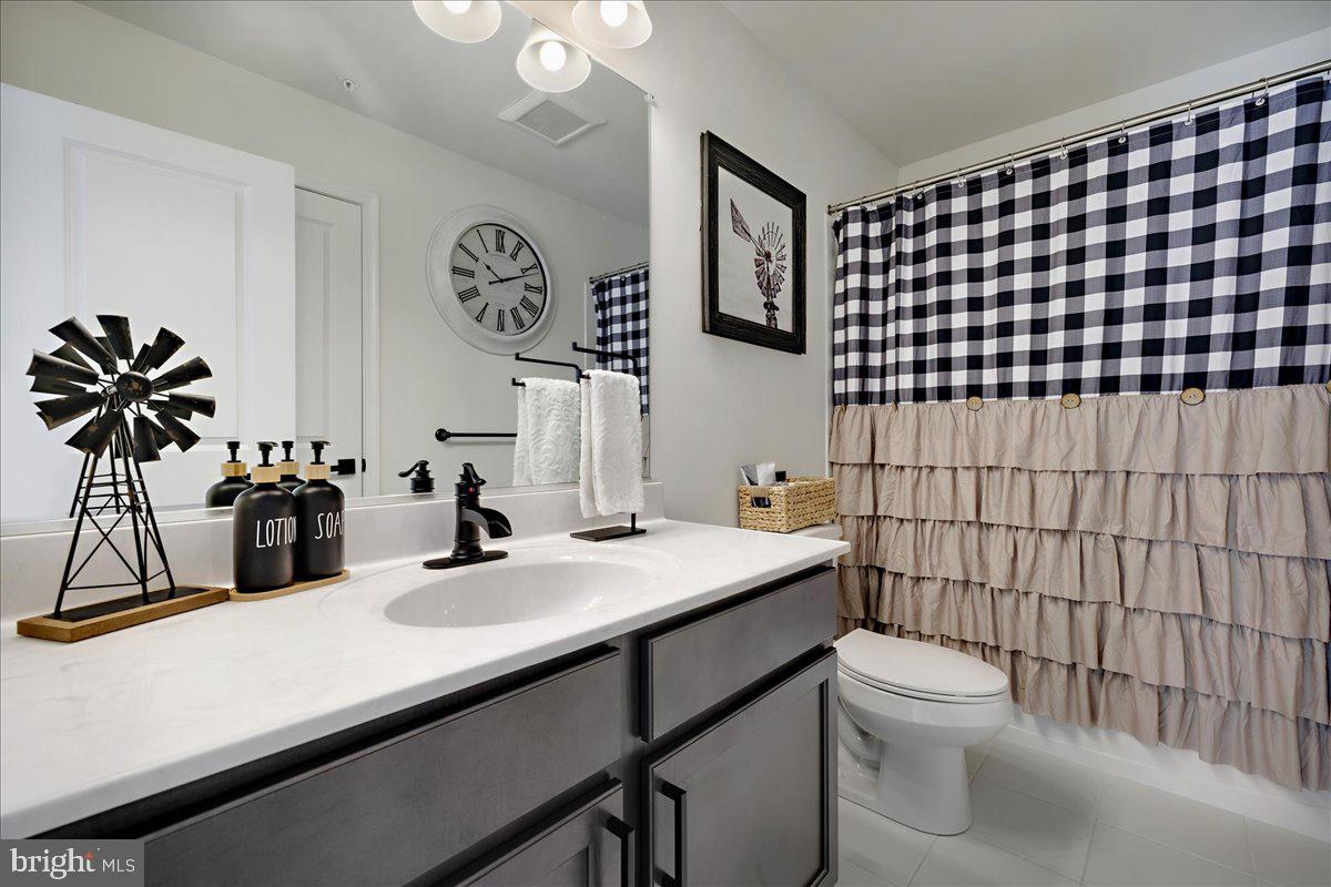 21 Greensborough Road Reisterstown, MD 21136 - Photo 25 of 54 a bathroom with a sink mirror vanity and toilet