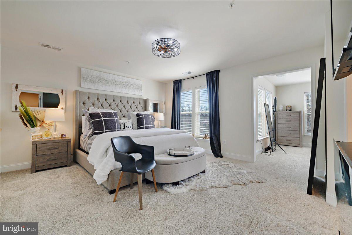 21 Greensborough Road Reisterstown, MD 21136 - Photo 27 of 54 a bedroom with a bed and a chandelier