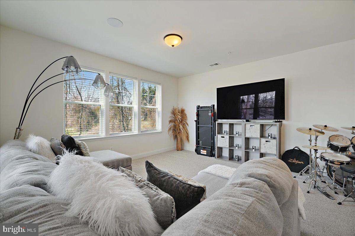 21 Greensborough Road Reisterstown, MD 21136 - Photo 39 of 54 a living room with furniture a flat screen tv and a large window
