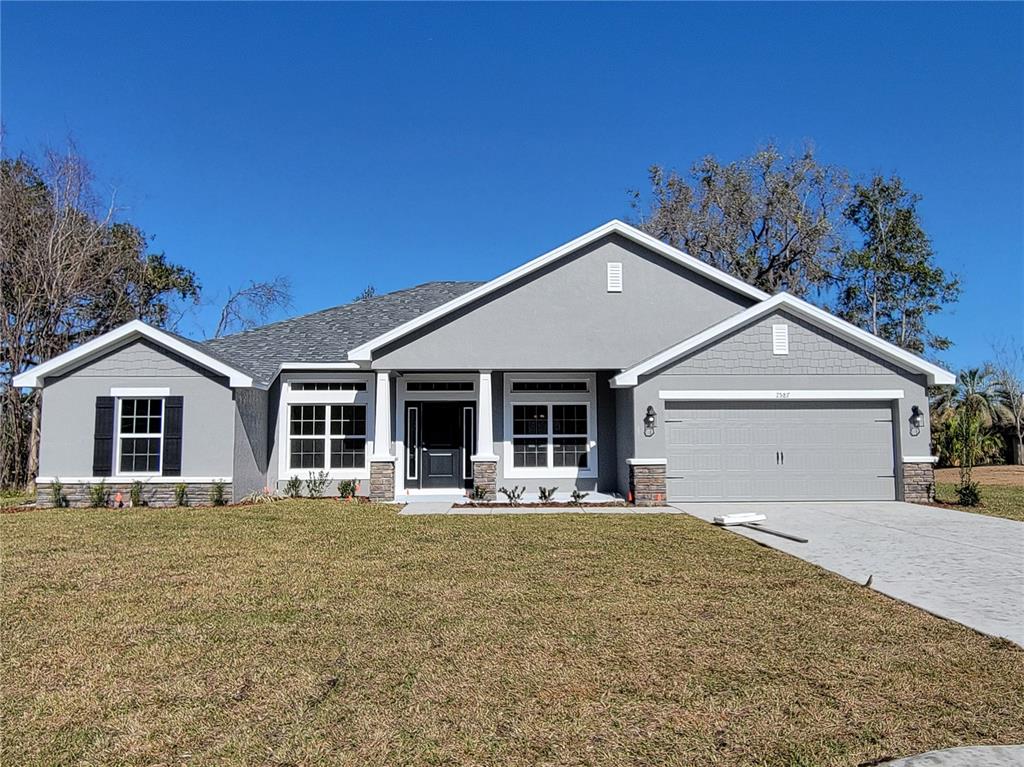7587 Southwest 103rd Loop Ocala, FL 34476 - Photo 1 of 1 a front view of a house with yard
