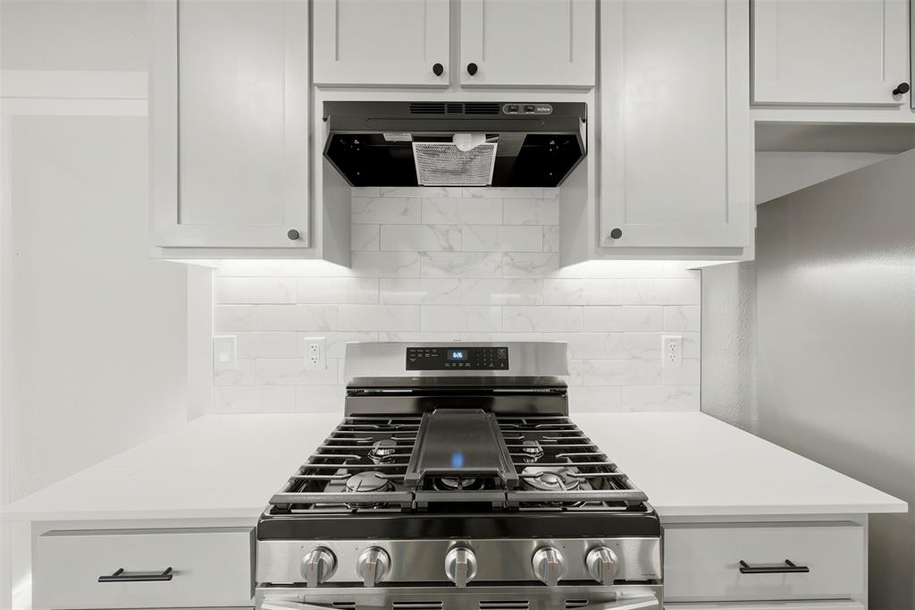502 Madison Street Cleburne, TX 76033 - Photo 7 of 30 a stove top oven sitting inside of a kitchen