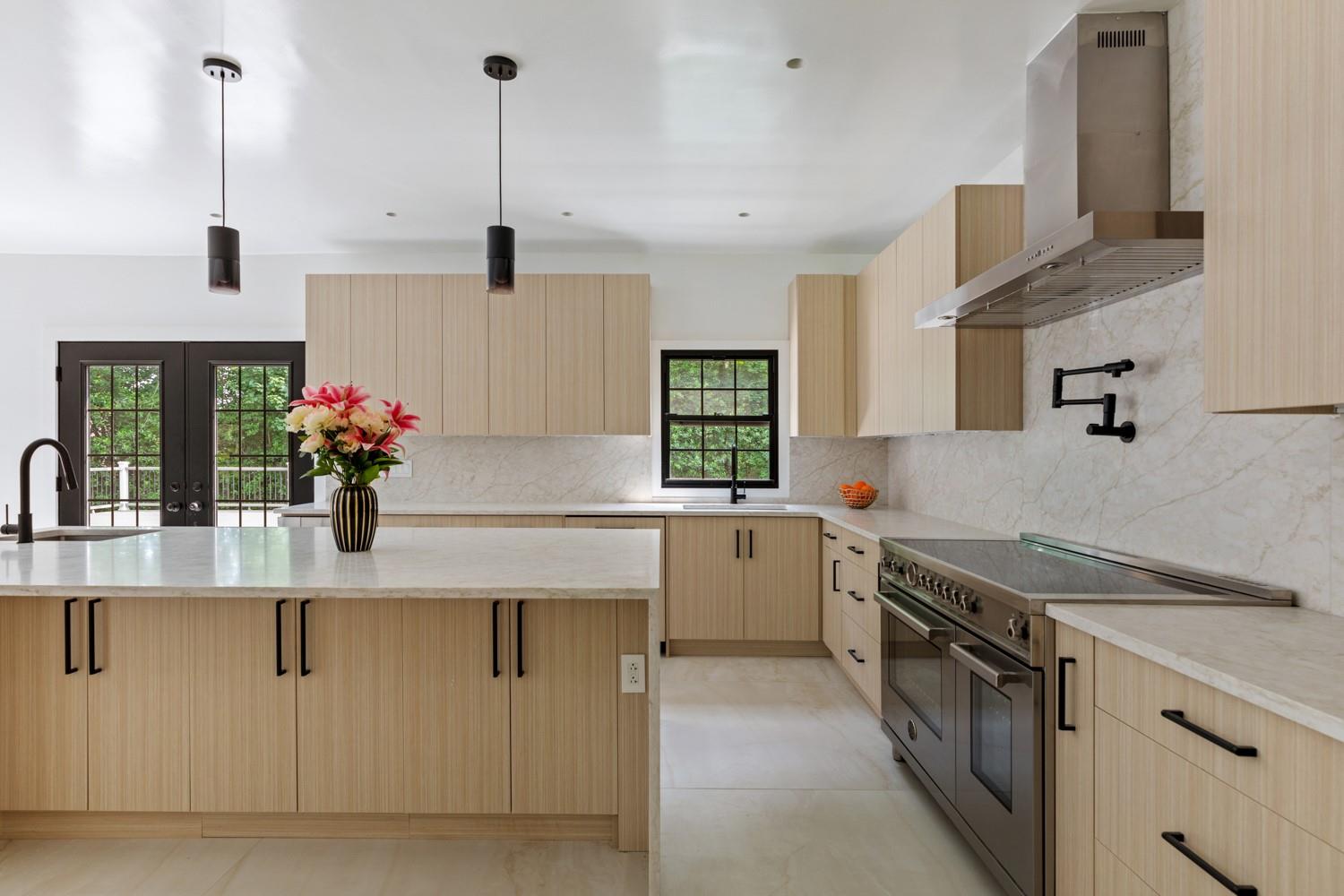 33 High Farms Road Glen Head, NY 11545 - Photo 13 of 35 Kitchen featuring light brown cabinets, double oven range, wall chimney exhaust hood, tasteful backsplash, and french doors
