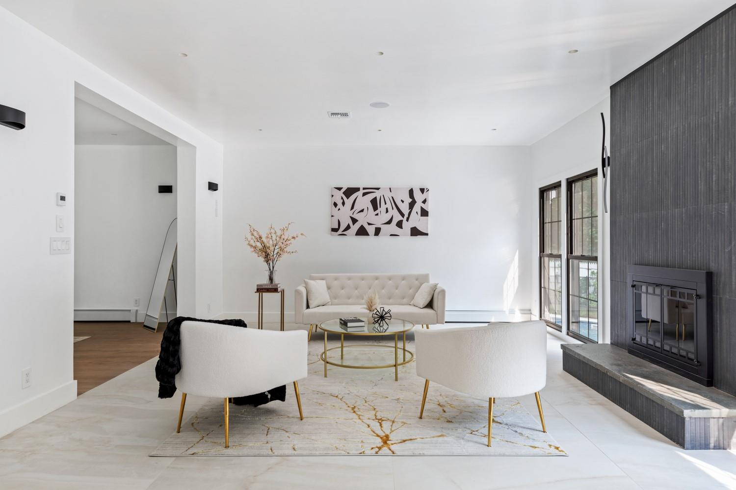 33 High Farms Road Glen Head, NY 11545 - Photo 14 of 35 Living area with a fireplace and a baseboard heating unit