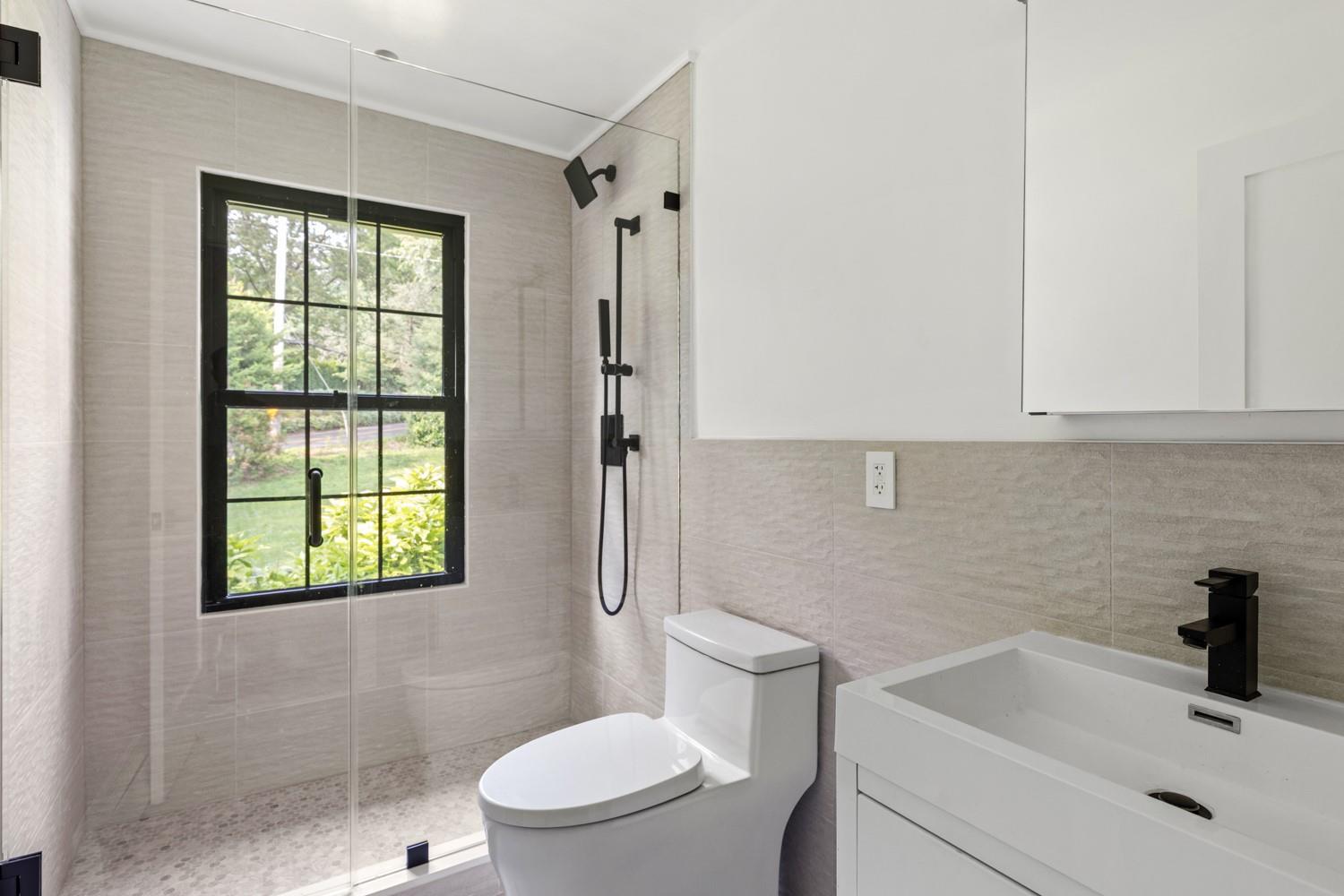 33 High Farms Road Glen Head, NY 11545 - Photo 16 of 35 1st Floor Bathroom featuring tile walls, vanity, and a tile shower