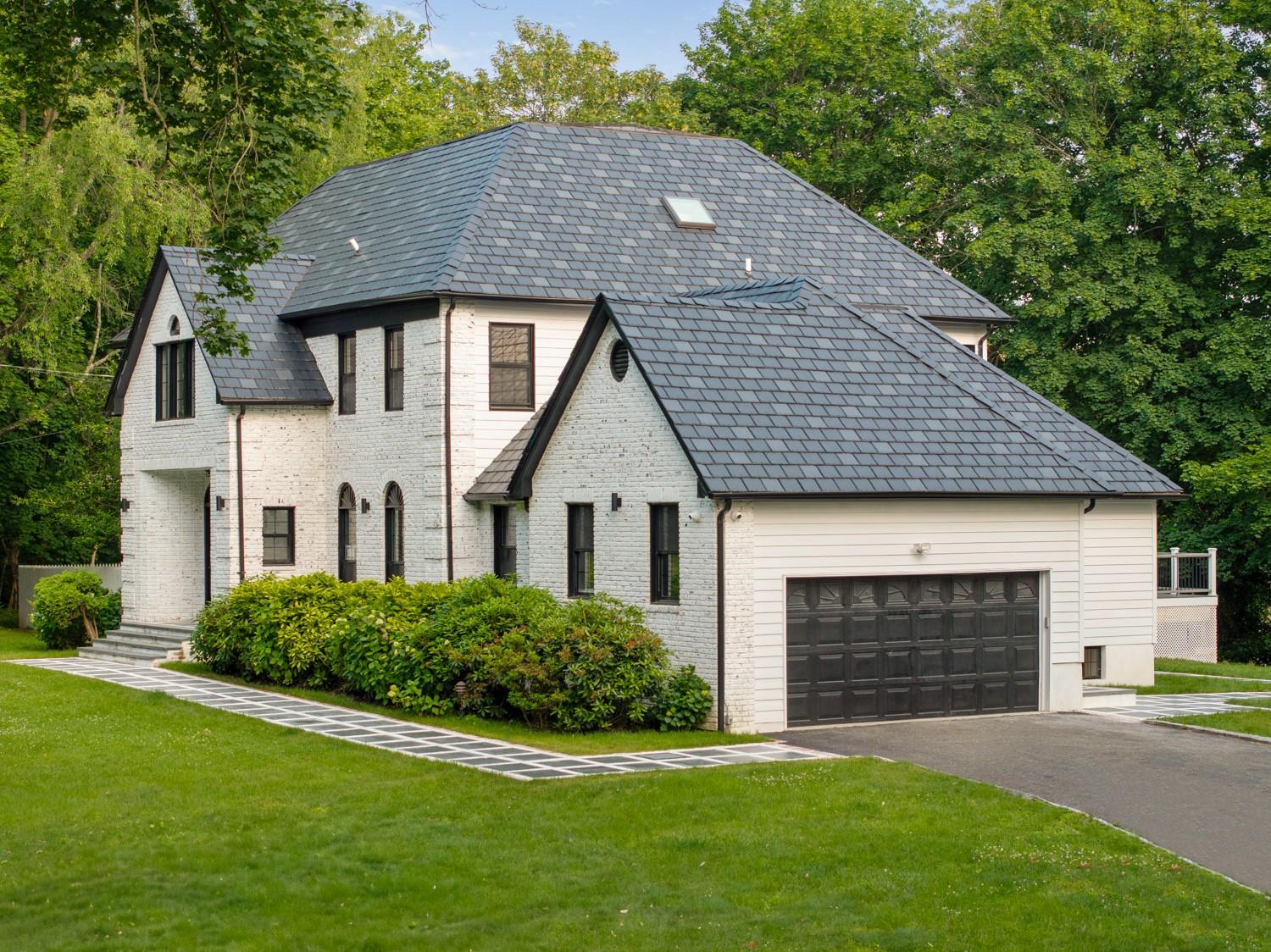 33 High Farms Road Glen Head, NY 11545 - Photo 2 of 35 French provincial home featuring asphalt driveway, brick siding, a front lawn, a garage, and a high end roof