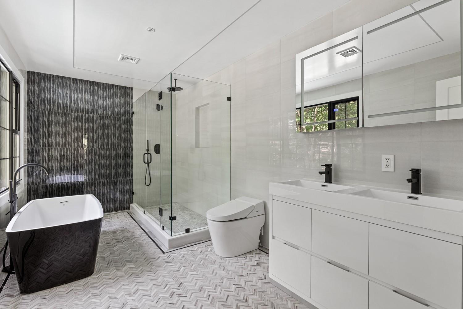 33 High Farms Road Glen Head, NY 11545 - Photo 20 of 35 Bathroom featuring tile walls, a shower stall, a freestanding bath, and double vanity