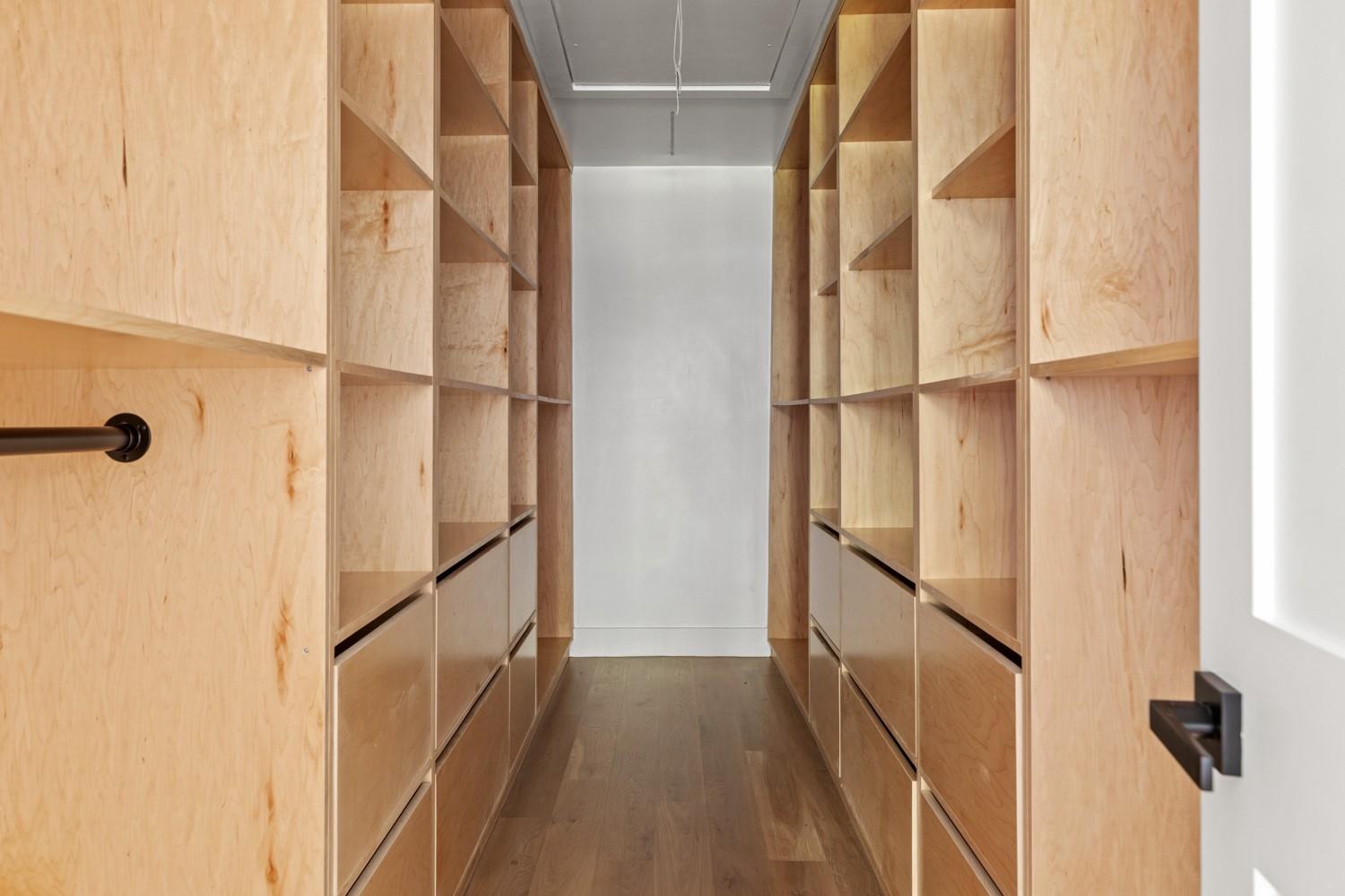 33 High Farms Road Glen Head, NY 11545 - Photo 22 of 35 Spacious closet with attic access and dark wood finished floors