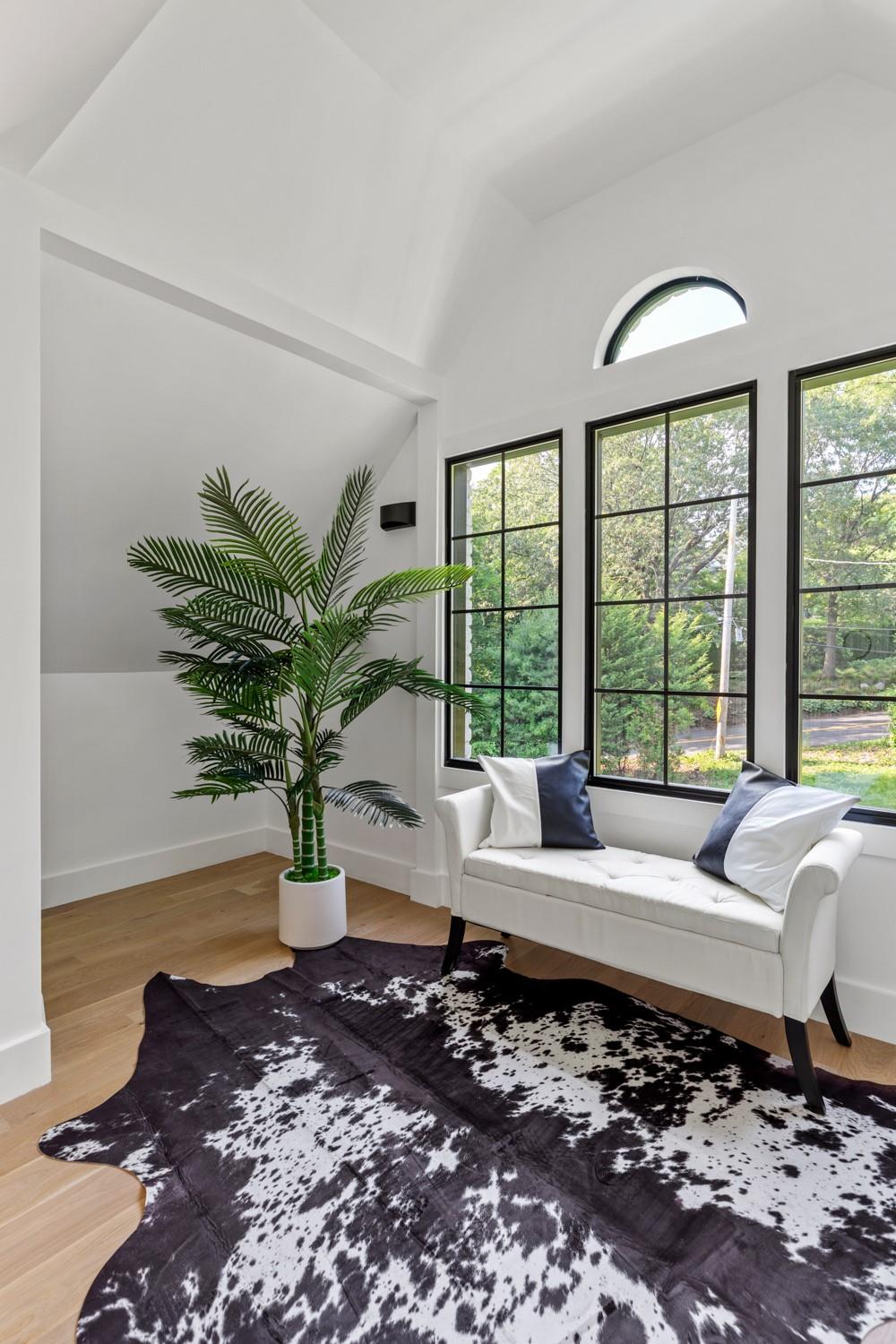 33 High Farms Road Glen Head, NY 11545 - Photo 23 of 35 Living area featuring vaulted ceiling and wood finished floors