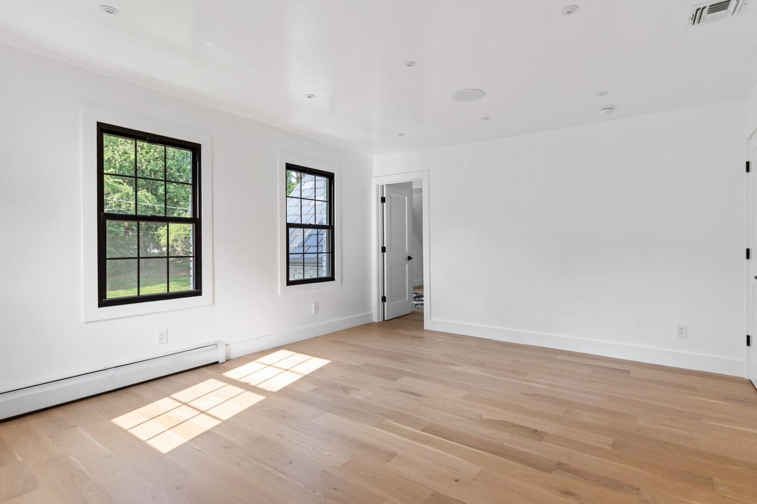 33 High Farms Road Glen Head, NY 11545 - Photo 27 of 35 Spare room with light wood-type flooring and a baseboard heating unit