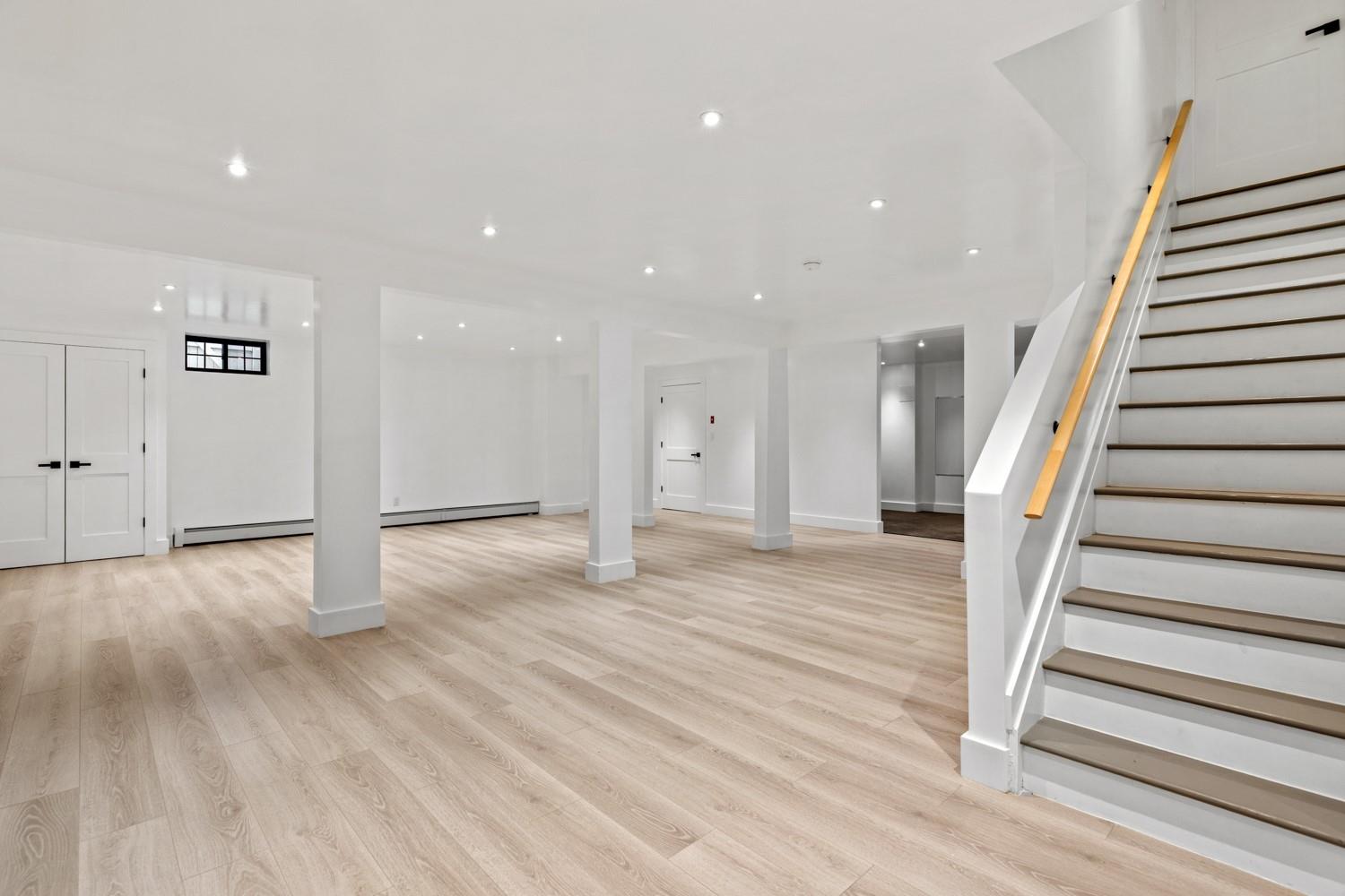 33 High Farms Road Glen Head, NY 11545 - Photo 28 of 35 Below grade area featuring stairs, light wood-style floors, recessed lighting, and baseboard heating