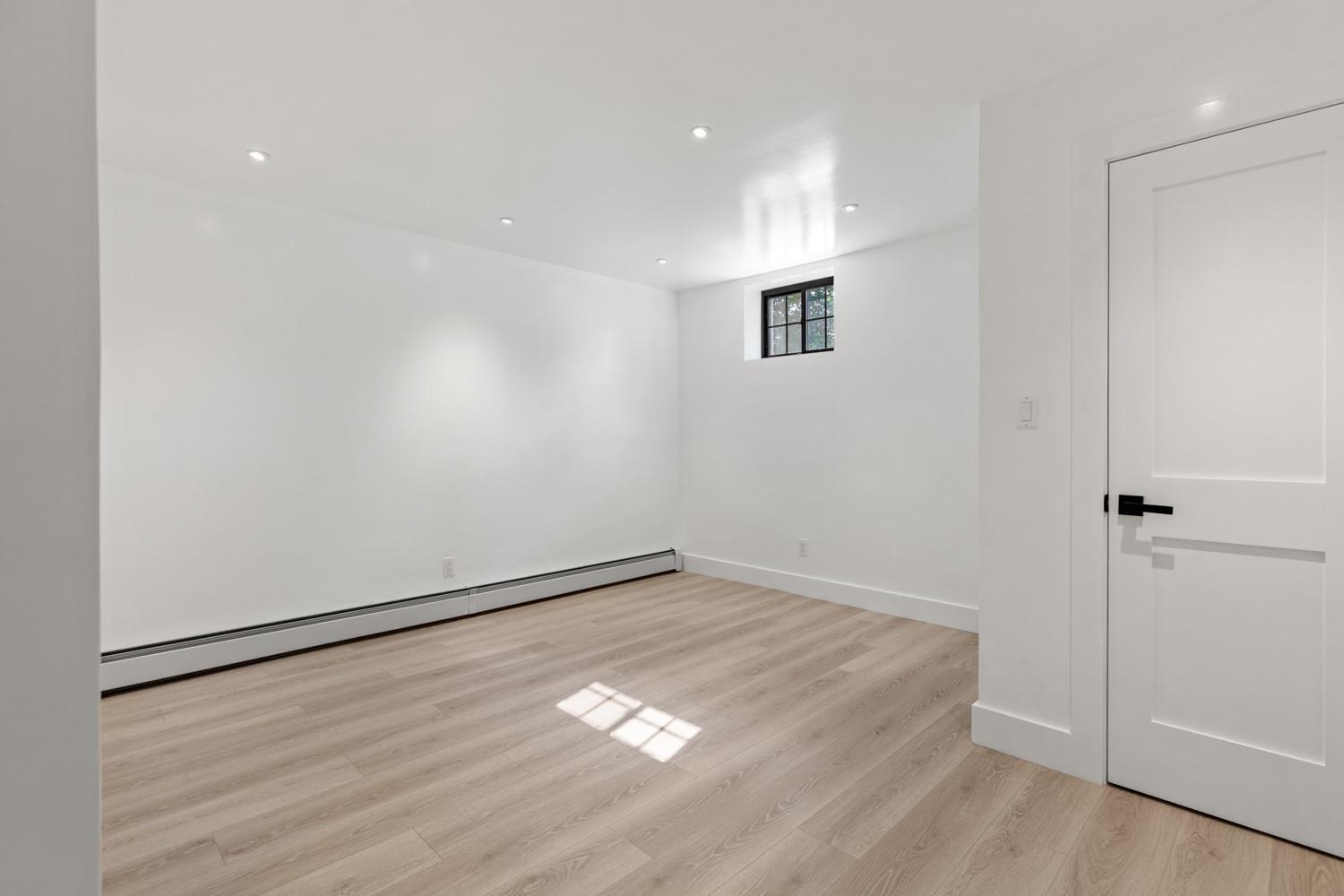 33 High Farms Road Glen Head, NY 11545 - Photo 32 of 35 Lower Level Basement featuring wood finished floors, a baseboard radiator, and recessed lighting