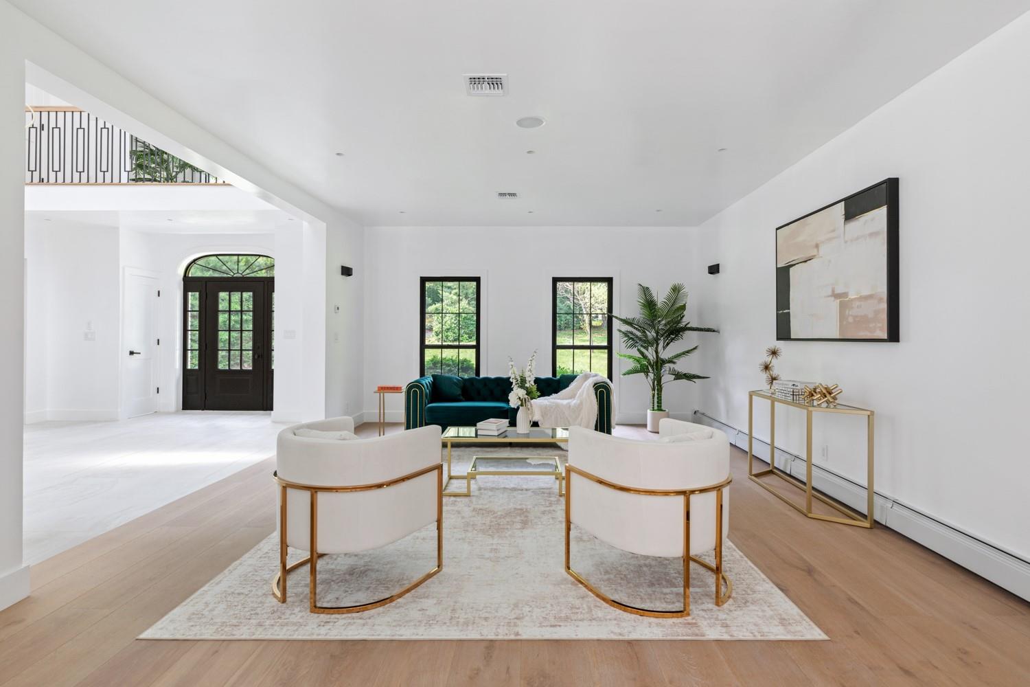 33 High Farms Road Glen Head, NY 11545 - Photo 10 of 35 Living room with light wood-style floors and a baseboard heating unit