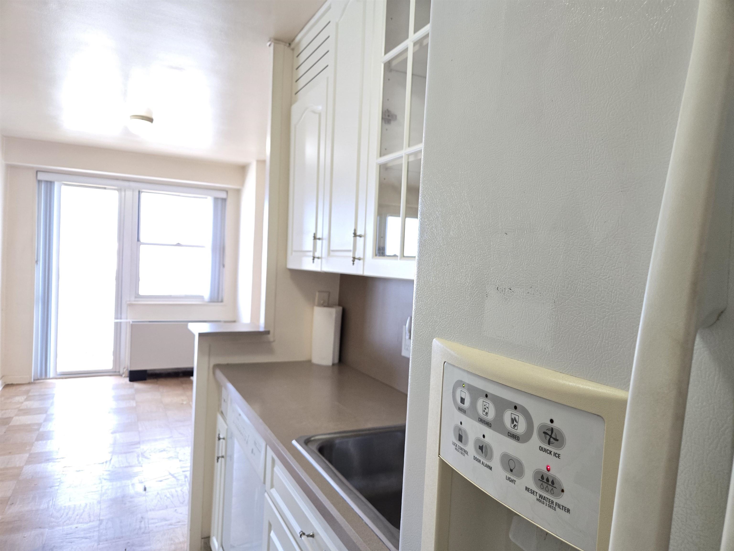 6600 Boulevard East, Unit 15D West New York, NJ 07093 - Photo 11 of 29 a kitchen with stainless steel appliances a sink a stove and a window