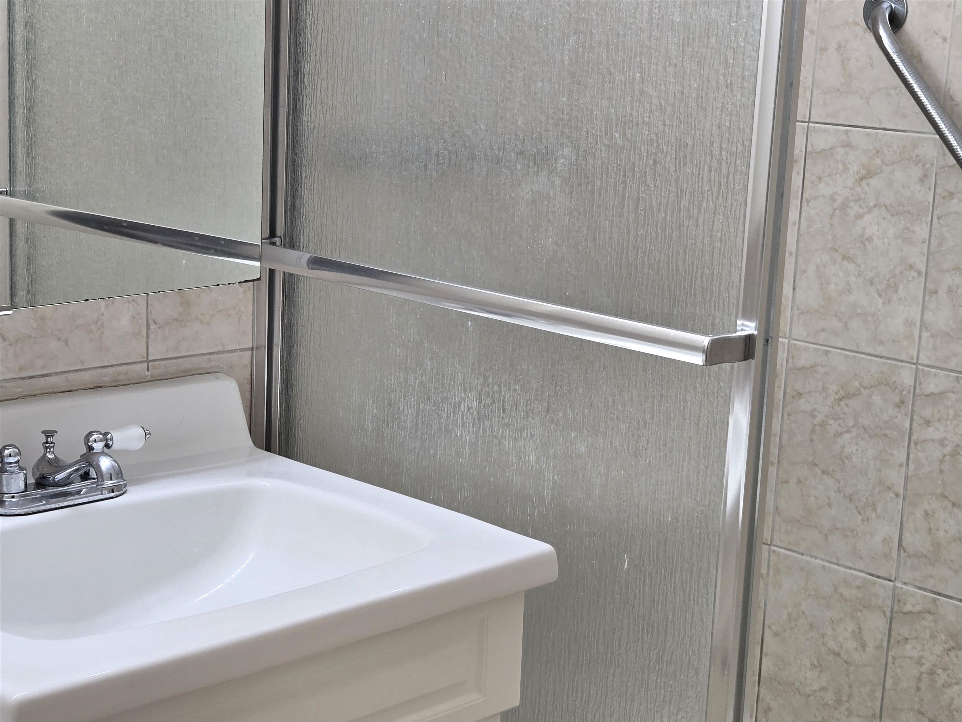 6600 Boulevard East, Unit 15D West New York, NJ 07093 - Photo 13 of 29 a bathroom with a sink and shower