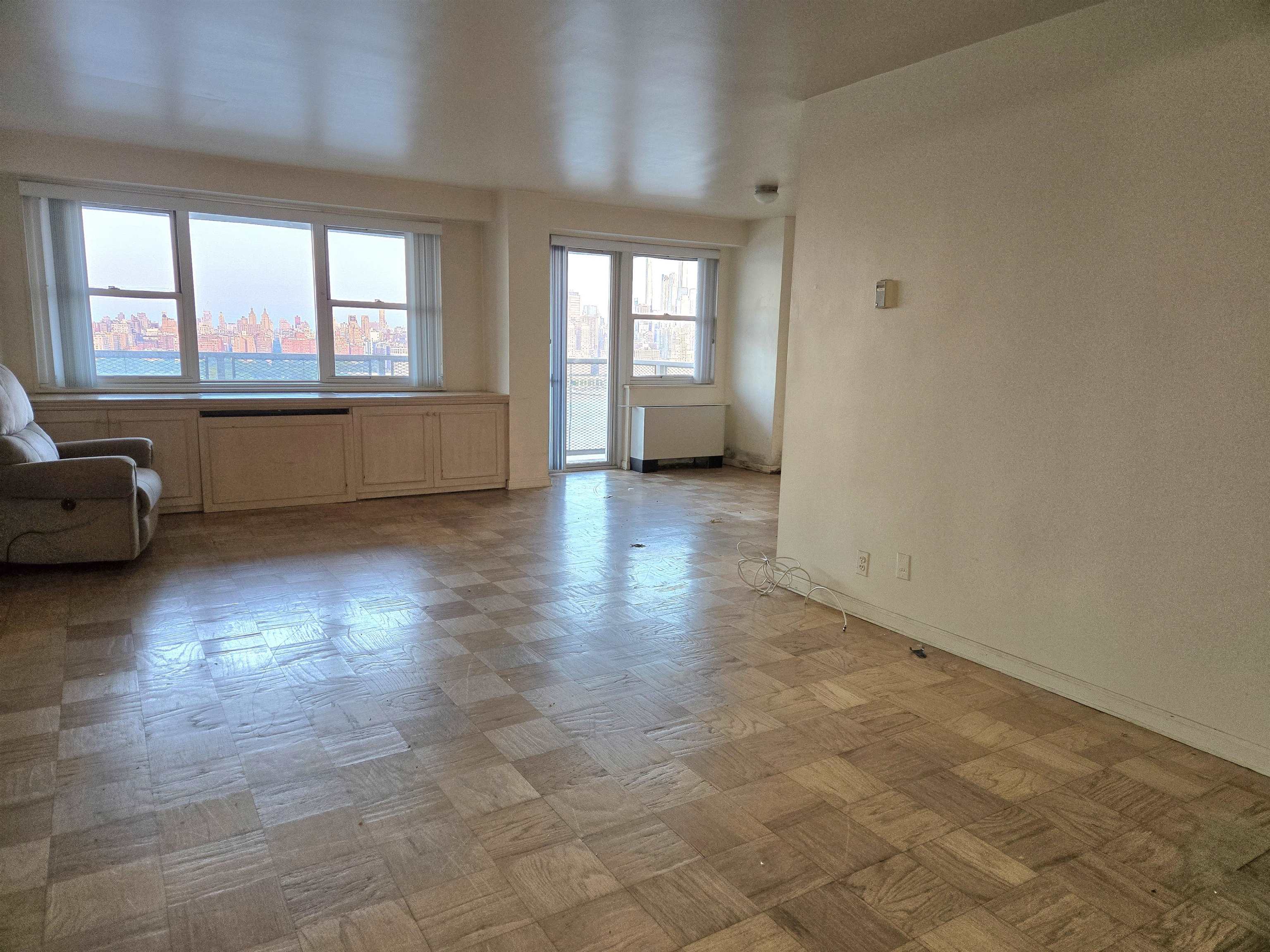 6600 Boulevard East, Unit 15D West New York, NJ 07093 - Photo 5 of 29 wooden floor in an empty room with a window