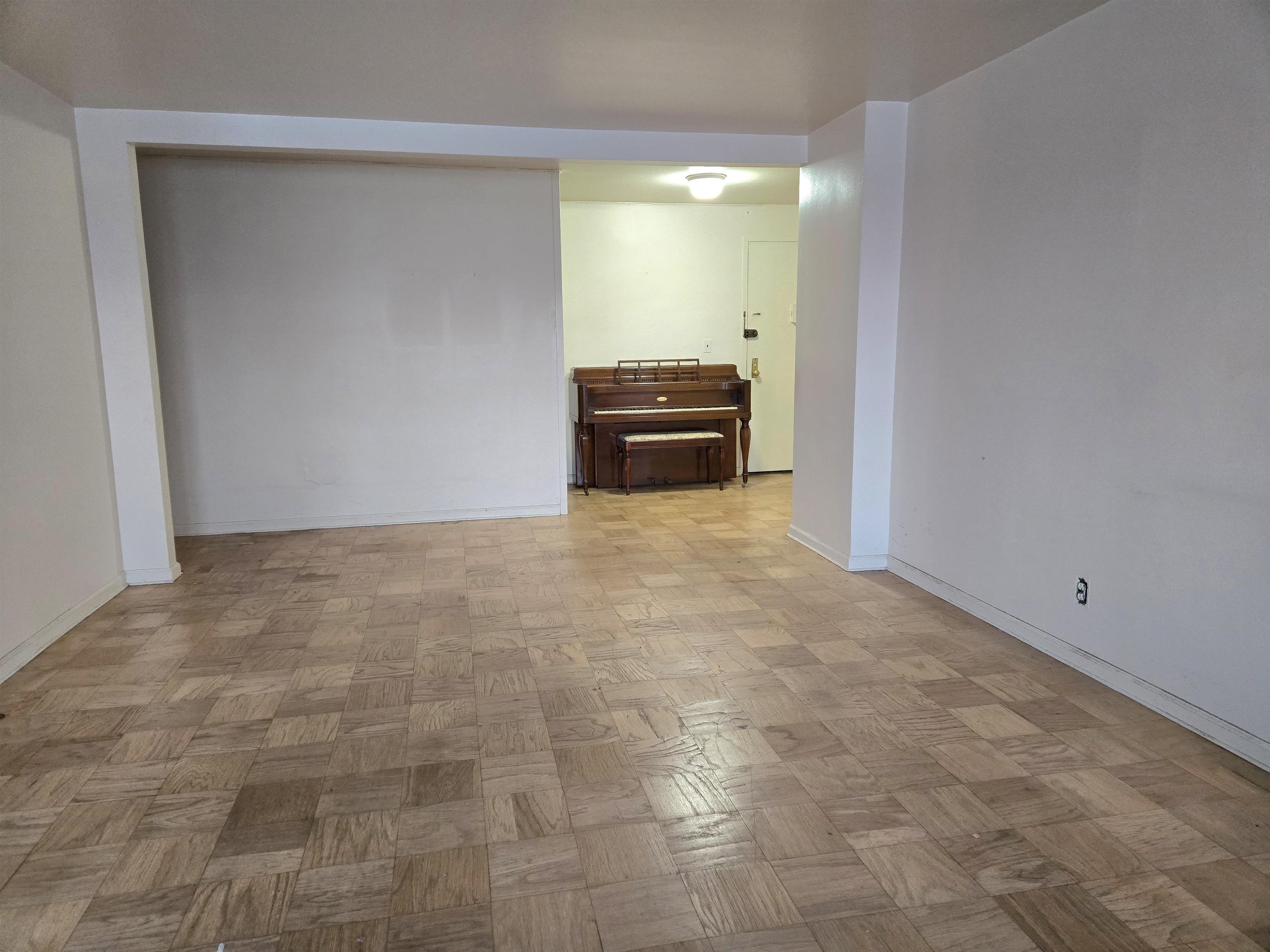 6600 Boulevard East, Unit 15D West New York, NJ 07093 - Photo 6 of 29 a view of a livingroom with kitchen appliances and cabinets