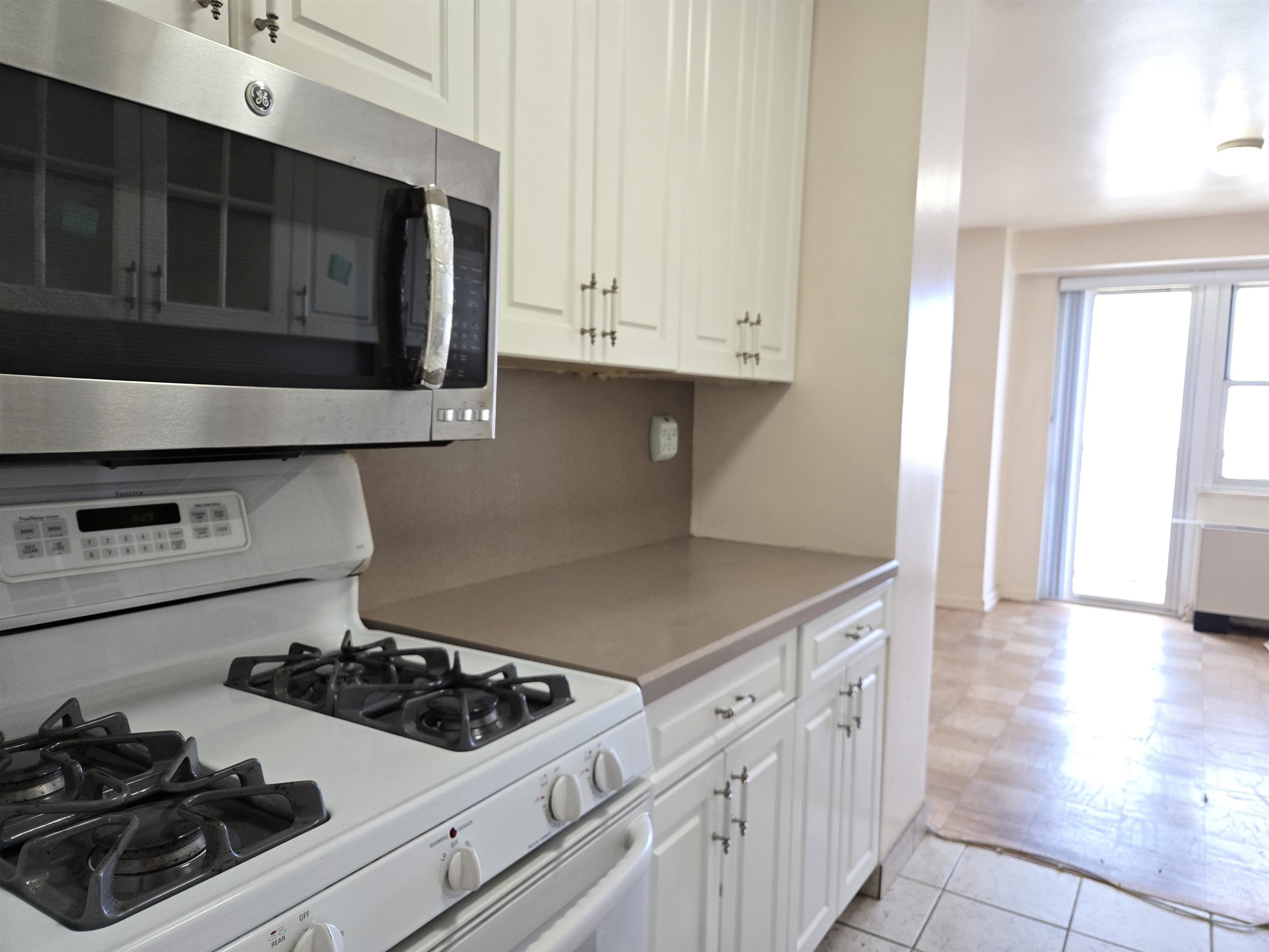 6600 Boulevard East, Unit 15D West New York, NJ 07093 - Photo 9 of 29 a kitchen with white cabinets and appliances