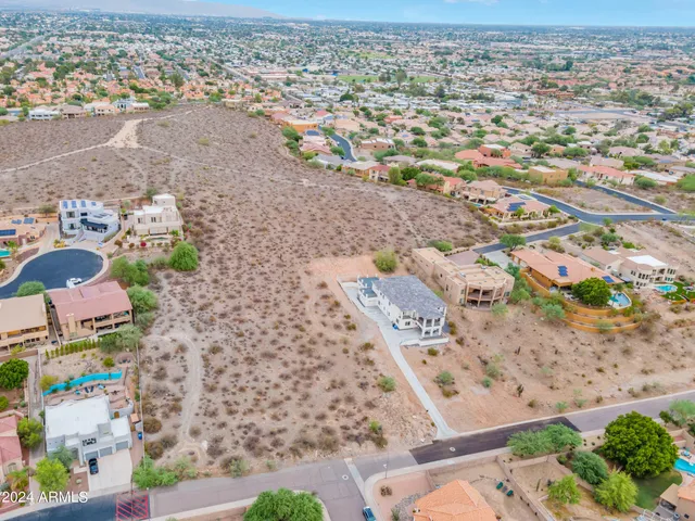 a view of a dry yard with wooden fence