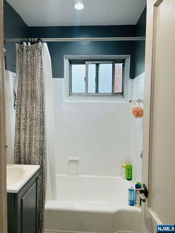 1480 Terrace, Unit 4 Teaneck, NJ 07666 - Photo 6 of 14 a bathroom with a shower curtain and a sink