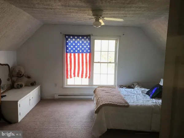 a bed sitting in a bedroom next to a window