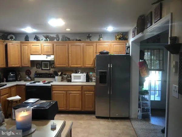 a kitchen with refrigerator and cabinets