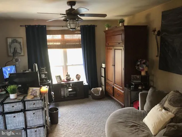 a living room with furniture a chandelier and a window