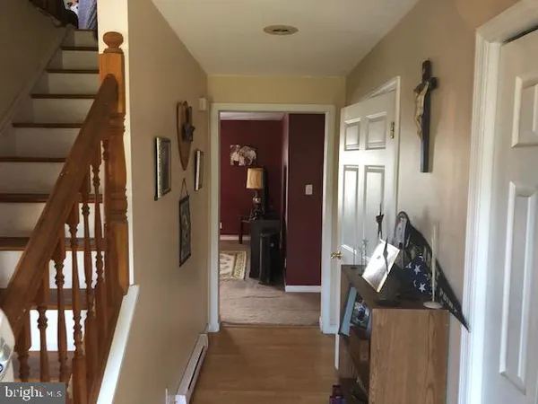 a view of an entryway with wooden floor
