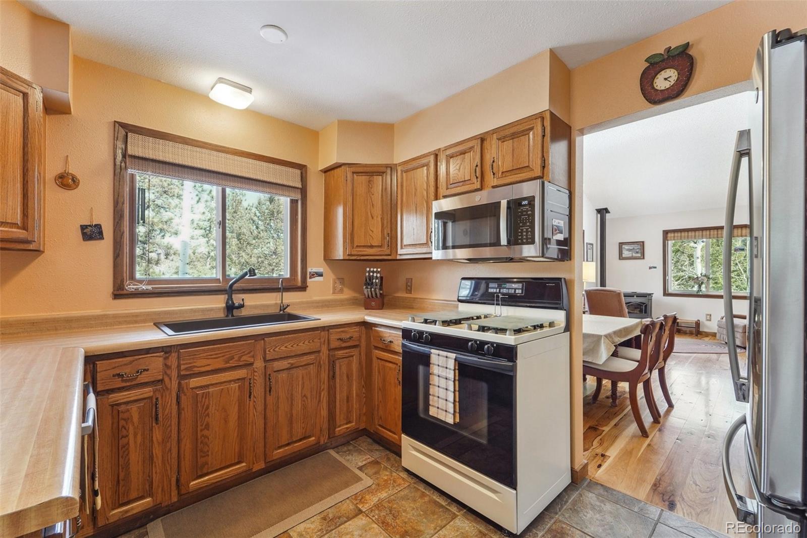 246 Tapadero Road Bailey, CO 80421 - Photo 14 of 50 a kitchen with a stove a sink and a microwave