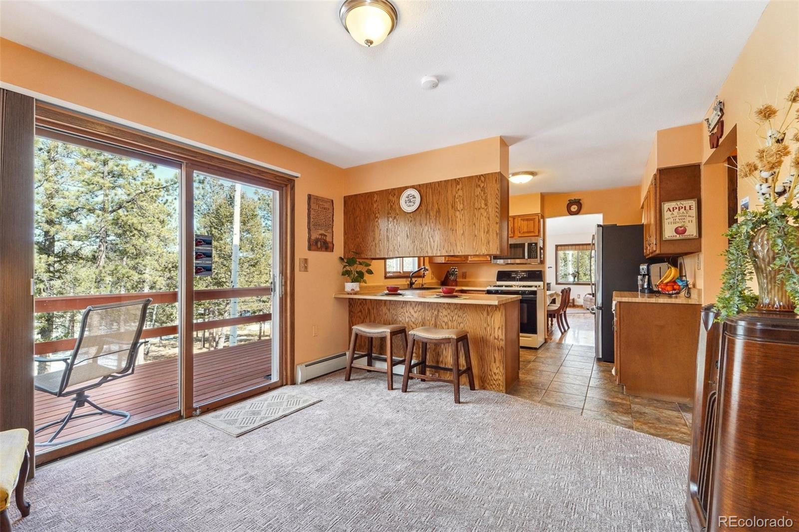246 Tapadero Road Bailey, CO 80421 - Photo 17 of 50 a view of a kitchen with kitchen island and a large window