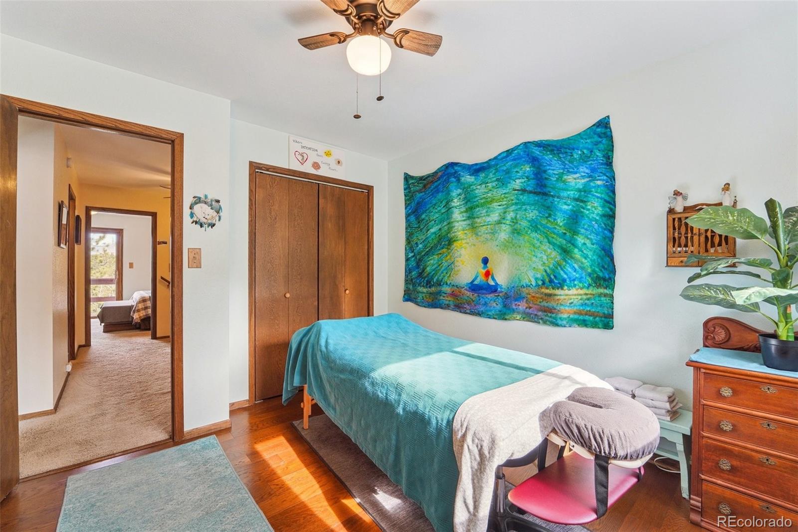246 Tapadero Road Bailey, CO 80421 - Photo 32 of 50 a bedroom with a bed and a painting on the wall